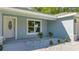 Front entrance with white door, light blue exterior, and landscaping at 28 Pecan Run, Ocala, FL 34472