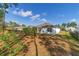 Sunny backyard with a view of the house and surrounding trees at 451 Hickory Course Loop, Ocala, FL 34472