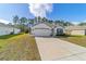 One-story house with a two-car garage and driveway at 451 Hickory Course Loop, Ocala, FL 34472