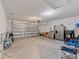 Garage with concrete floor, shelving, and refrigerator at 451 Hickory Course Loop, Ocala, FL 34472