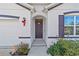 Front door entry with decorative accents and landscaping at 451 Hickory Course Loop, Ocala, FL 34472