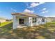 Back of house showing covered patio and yard at 451 Hickory Course Loop, Ocala, FL 34472