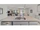 Kitchen island with granite countertop and double sink overlooking living room at 451 Hickory Course Loop, Ocala, FL 34472