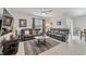 Open living area with grey couches, coffee table and a view of the kitchen at 451 Hickory Course Loop, Ocala, FL 34472