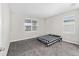 Spacious bedroom with gray carpeting and a black and white checkered bedspread at 5779 Sw 87Th Court Rd, Ocala, FL 34481