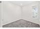 Bright bedroom with grey carpet and window with blinds at 5779 Sw 87Th Court Rd, Ocala, FL 34481