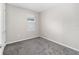 Empty bedroom with gray carpeting and a window with blinds at 5779 Sw 87Th Court Rd, Ocala, FL 34481