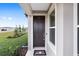 Dark brown front door with sidelight window at 5779 Sw 87Th Court Rd, Ocala, FL 34481