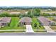 Neighborhood street view of a single Gathering home with two car garage, manicured lawns, and landscaping at 6365 Sw 88Th Loop, Ocala, FL 34476