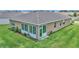 Backyard of the home featuring a sunroom with sliding glass doors and outdoor patio space at 6365 Sw 88Th Loop, Ocala, FL 34476