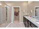 Elegant bathroom with double vanity, granite countertops, and walk-in shower at 6365 Sw 88Th Loop, Ocala, FL 34476