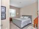 Gray bedroom with wood furniture and window at 6365 Sw 88Th Loop, Ocala, FL 34476