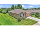 Well-maintained home with a two-car garage, stone accents, and a spacious, green lawn at 6365 Sw 88Th Loop, Ocala, FL 34476