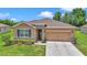 Inviting home with stone details, well-kept lawn, two-car garage, and neutral color scheme at 6365 Sw 88Th Loop, Ocala, FL 34476
