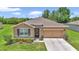 Beautiful single-story home featuring stone accents, manicured landscaping, and a two-car garage at 6365 Sw 88Th Loop, Ocala, FL 34476