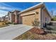 Two-car garage with tan doors and stone accents at 6365 Sw 88Th Loop, Ocala, FL 34476