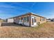 House exterior showcasing a sunroom and backyard at 6365 Sw 88Th Loop, Ocala, FL 34476