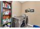 Bright laundry room with washer, dryer, and ample storage at 6365 Sw 88Th Loop, Ocala, FL 34476