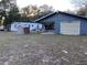 Spacious backyard with various buildings, providing ample space for outdoor activities at 11064 Ne 212Th Ln, Fort Mc Coy, FL 32134