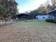 Large backyard with covered shelter, storage shed, and fenced area at 11064 Ne 212Th Ln, Fort Mc Coy, FL 32134