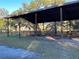 View of the covered barn area featuring sturdy wooden supports and ample space at 11064 Ne 212Th Ln, Fort Mc Coy, FL 32134