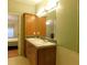 Bathroom with double sinks and wood cabinetry at 11064 Ne 212Th Ln, Fort Mc Coy, FL 32134