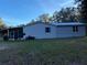 Single-wide manufactured home with covered porch and spacious yard at 11064 Ne 212Th Ln, Fort Mc Coy, FL 32134