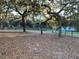 Exterior shot of horse property with barn and fencing, set amongst mature shade trees at 11064 Ne 212Th Ln, Fort Mc Coy, FL 32134