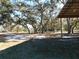 Grounds with mature trees and leaf-covered sandy ground at 11064 Ne 212Th Ln, Fort Mc Coy, FL 32134