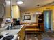 Charming kitchen with yellow cabinets and breakfast nook at 11064 Ne 212Th Ln, Fort Mc Coy, FL 32134