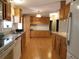 Spacious kitchen features laminate floor, wood cabinets, and breakfast bar at 11064 Ne 212Th Ln, Fort Mc Coy, FL 32134
