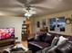 Relaxing living room with leather sofa and large TV at 11064 Ne 212Th Ln, Fort Mc Coy, FL 32134