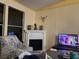 Cozy living room featuring a decorative fireplace and large windows for natural light at 11064 Ne 212Th Ln, Fort Mc Coy, FL 32134