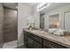 Modern bathroom with dark vanity and walk-in shower at 13351 Sw 83Rd Cir, Ocala, FL 34473