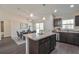 Modern kitchen with dark cabinets, stainless steel appliances and an island with seating at 13351 Sw 83Rd Cir, Ocala, FL 34473