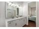 Bathroom with double vanity and a view into the bedroom at 15851 Nw 115Th Ct, Reddick, FL 32686