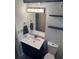 Nicely appointed bathroom featuring a vanity with storage, toilet and decorative shelving at 16510 Se 49Th Street Road, Ocklawaha, FL 32179