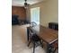 Inviting living room with a decorative fireplace, wood paneling, and an adjacent sunroom area for relaxation at 16510 Se 49Th Street Road, Ocklawaha, FL 32179