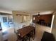 Open living room with wood-burning fireplace, dining table, and view into the kitchen at 16510 Se 49Th Street Road, Ocklawaha, FL 32179