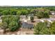 New construction house with dark shingles surrounded by green trees in a quiet area at 174 Pine Crse, Ocala, FL 34472