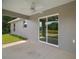 Covered back patio with a ceiling fan and a view of the backyard through sliding glass doors at 174 Pine Crse, Ocala, FL 34472