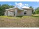 Back exterior features siding with covered porch, ceiling fan, and windows at 174 Pine Crse, Ocala, FL 34472