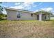 Back exterior features siding with covered porch, windows, and lawn at 174 Pine Crse, Ocala, FL 34472