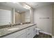 Bathroom featuring granite countertop vanity with double sinks and a tiled shower for a luxurious feel at 174 Pine Crse, Ocala, FL 34472