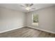 Cozy bedroom with neutral tones, a ceiling fan, and wood-look flooring, creating a comfortable and inviting space at 174 Pine Crse, Ocala, FL 34472