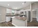 Modern kitchen with stainless steel appliances, granite countertops, a center island, and white cabinetry at 174 Pine Crse, Ocala, FL 34472