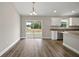 Kitchen featuring a sliding glass door, white cabinets, stainless steel appliances, and granite countertops at 174 Pine Crse, Ocala, FL 34472