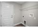 Functional laundry area with sleek door, shelf, and hookups for appliances at 174 Pine Crse, Ocala, FL 34472