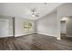 Spacious living room with a front door, large window, ceiling fan, and wood-look flooring at 174 Pine Crse, Ocala, FL 34472
