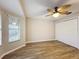 Bedroom with wood-look floors, ceiling fan, and double door closet at 2117 Sansores St, The Villages, FL 32159